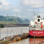 Cargo ship passing through Panama Canal locks near Panama City