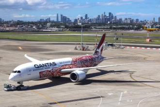 Qantas aircraft at Sydney Airport with Sydney skyline