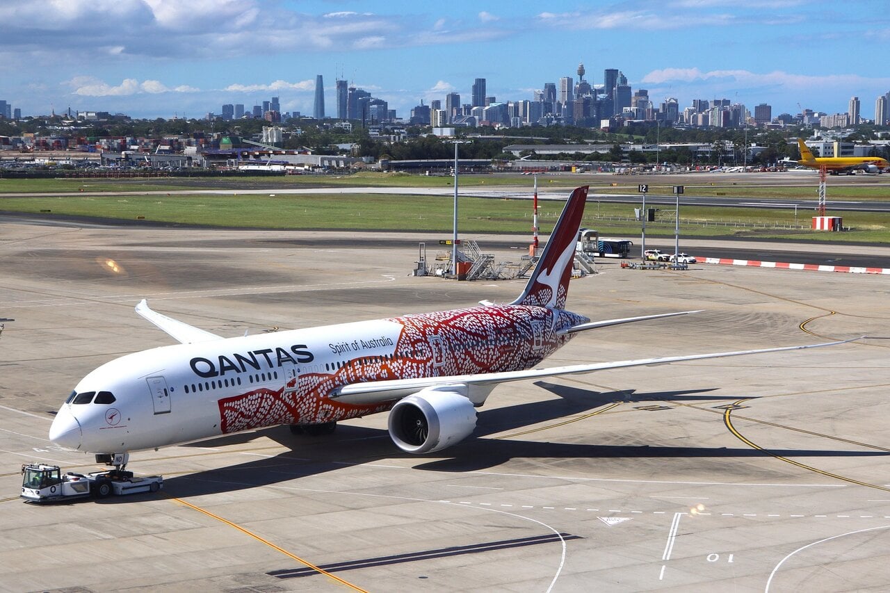Qantas aircraft at Sydney Airport with Sydney skyline