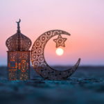 Travel during Ramadan: traditional lantern and crescent moon at sunset