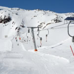 Drag lift and groomed piste at a budget ski resort