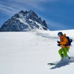 Skier standing on a snowy ridge in the French Alps