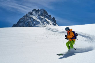 Skier standing on a snowy ridge in the French Alps