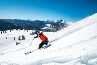 Skier skiing powder snow in Vail Colorado