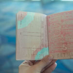 Passport with immigration stamps showing international travel and transit visas