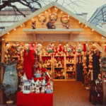 Traditional wooden Christmas market stall in the UK selling festive decorations and gifts