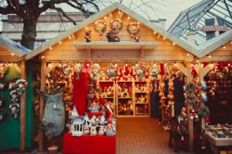 Traditional wooden Christmas market stall in the UK selling festive decorations and gifts