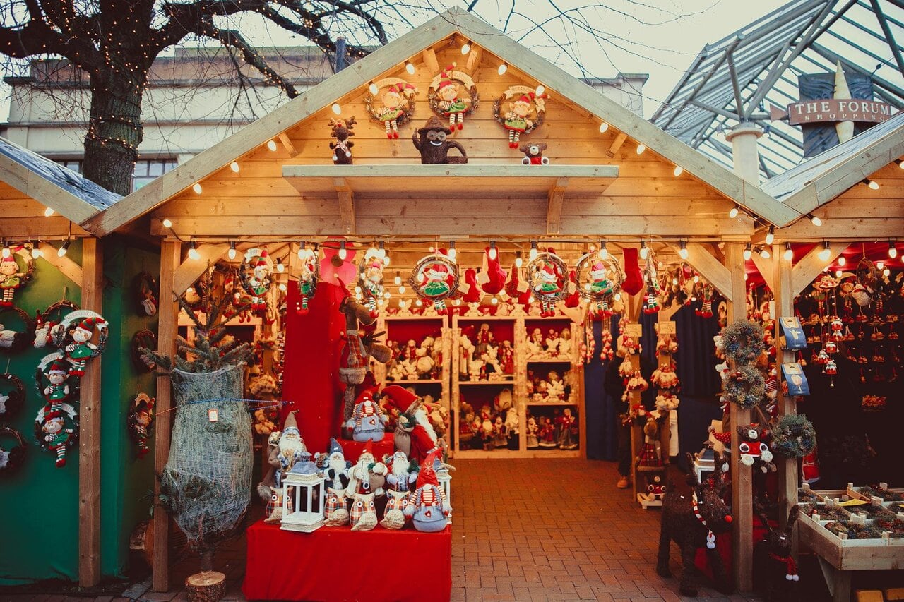 Traditional wooden Christmas market stall in the UK selling festive decorations and gifts