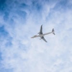 Commercial airplane flying high above clouds
