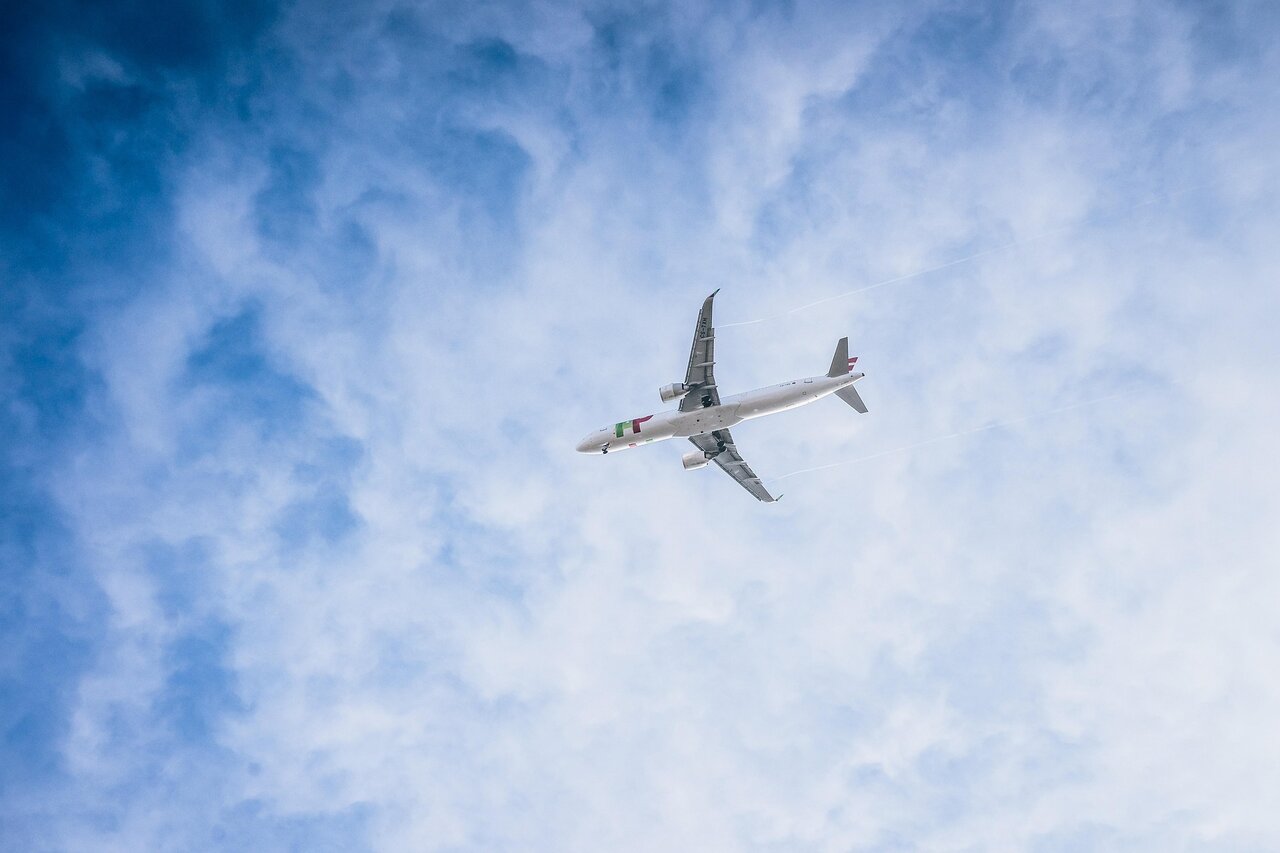 Commercial airplane flying high above clouds