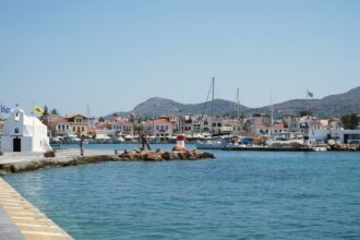 Aegina harbour waterfront Greece fishing boats and chapel