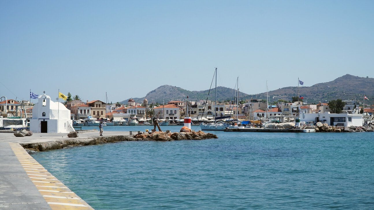Aegina harbour waterfront Greece fishing boats and chapel