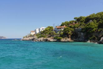 Agistri coastline turquoise water pine trees Saronic Gulf Greece