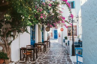 traditional Greek island street with bougainvillea in Milos