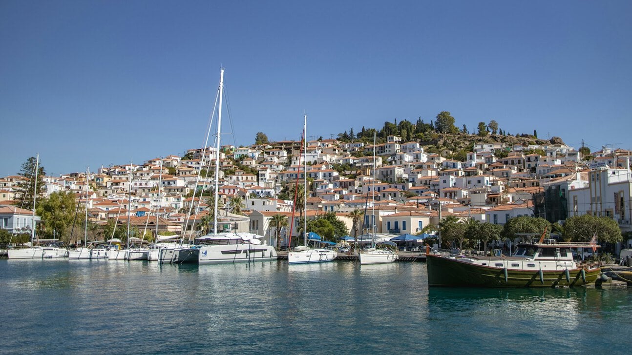 Poros harbour Greece with boats and hillside town