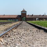 Railway tracks leading to Auschwitz-Birkenau entrance gate in Poland