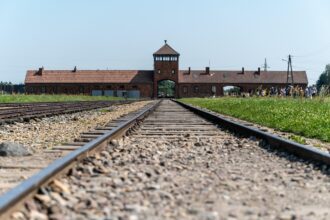 Railway tracks leading to Auschwitz-Birkenau entrance gate in Poland