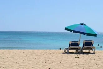 Barbados beach with sun loungers and umbrella on the south coast