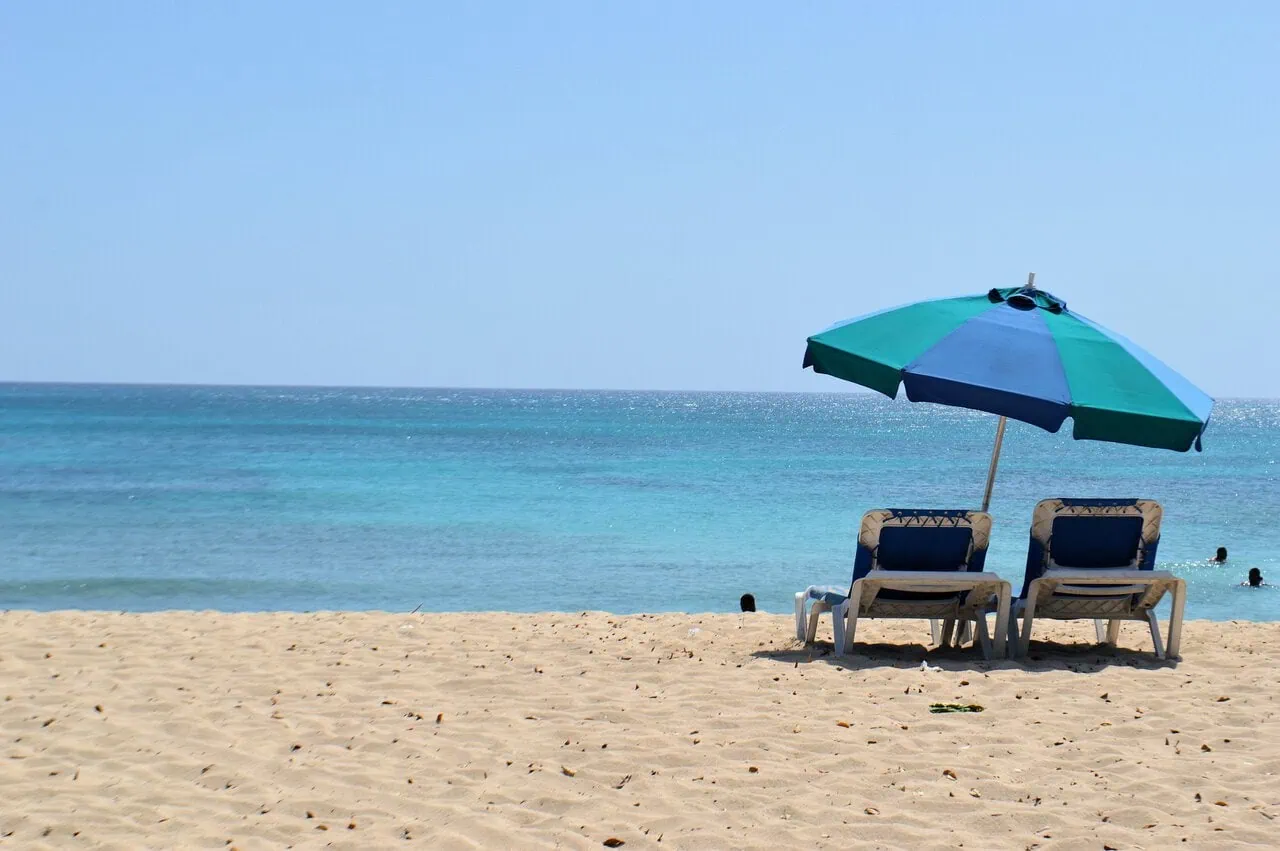 Barbados beach with sun loungers and umbrella on the south coast