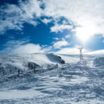 Skiing in Scotland at Cairngorm Mountain with chairlift and snowy Highlands landscape