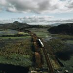 Cambrian line train crossing estuary landscape in Snowdonia Wales