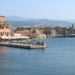 Chania Venetian harbour waterfront with historic buildings and mountains in Crete Greece