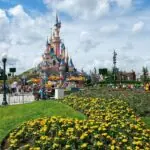 Sleeping Beauty Castle at Disneyland Paris with visitors in the park
