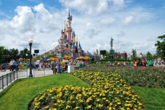 Sleeping Beauty Castle at Disneyland Paris with visitors in the park