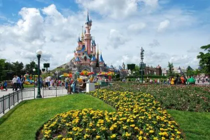 Sleeping Beauty Castle at Disneyland Paris with visitors in the park