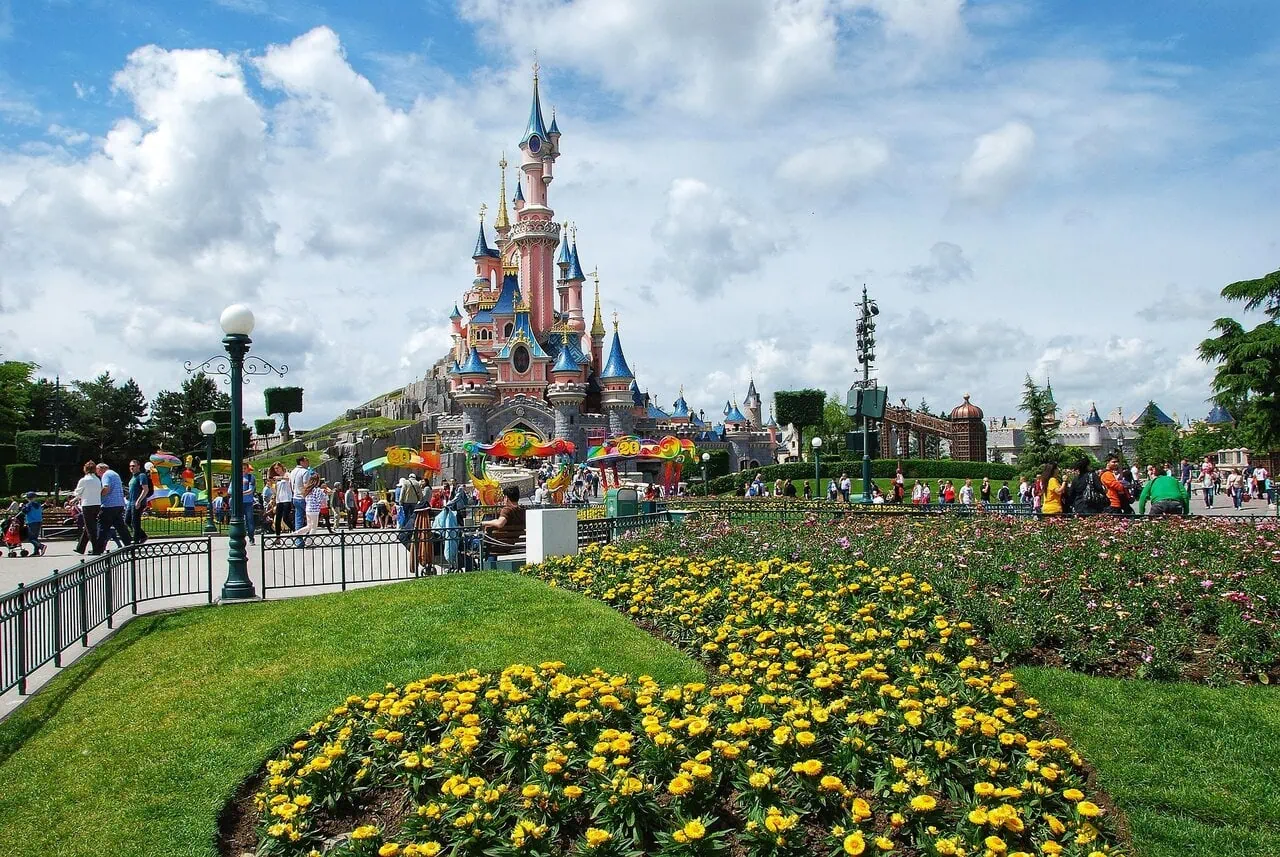 Sleeping Beauty Castle at Disneyland Paris with visitors in the park