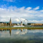 Düsseldorf skyline with Rhine river cruise boat and ferris wheel