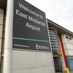 Welcome to East Midlands Airport sign outside the terminal building