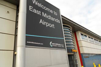 Welcome to East Midlands Airport sign outside the terminal building