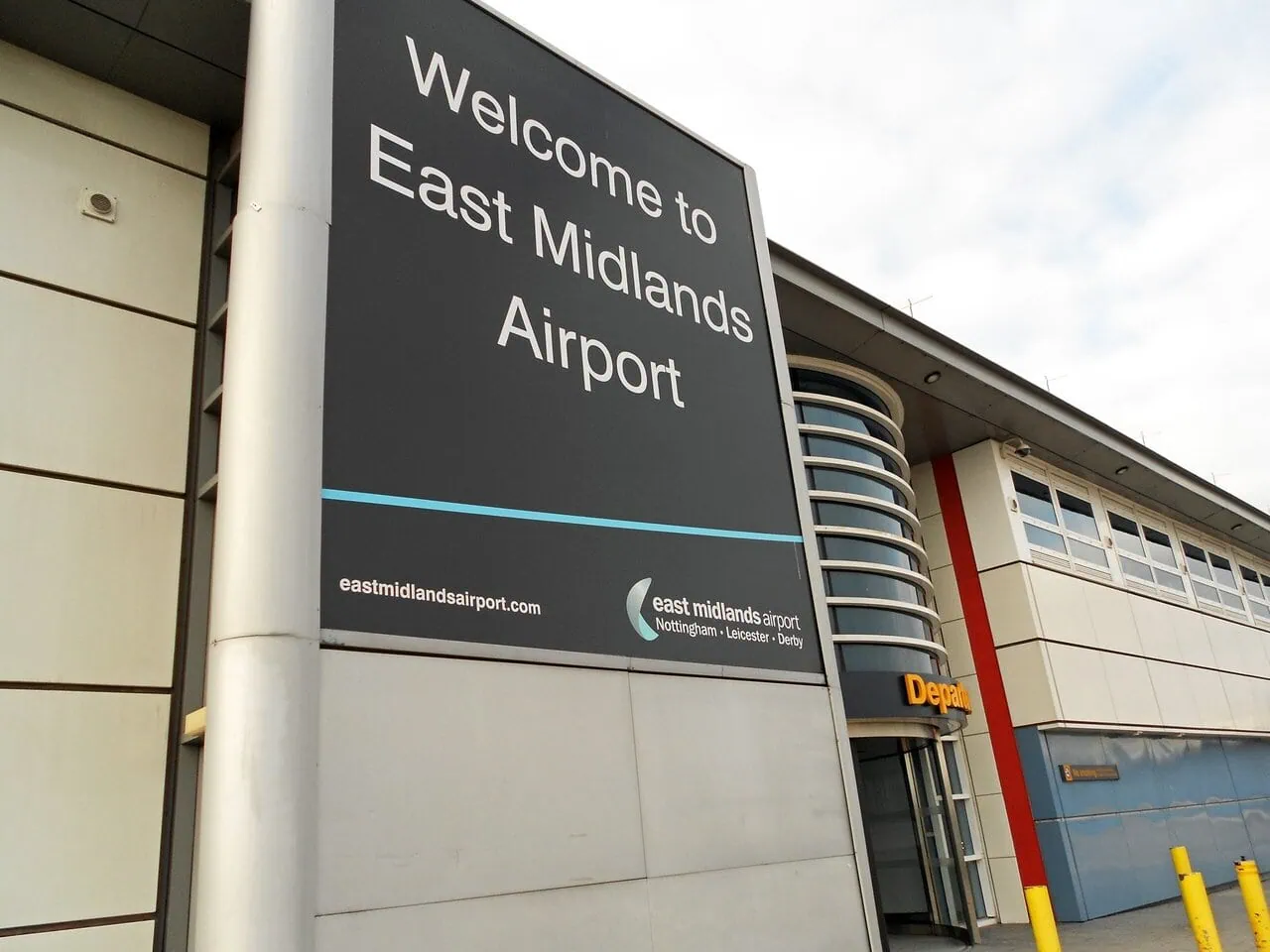 Welcome to East Midlands Airport sign outside the terminal building