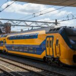 European double-decker train at station platform representing rail travel across Europe