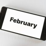 February travel planning on smartphone screen showing February calendar