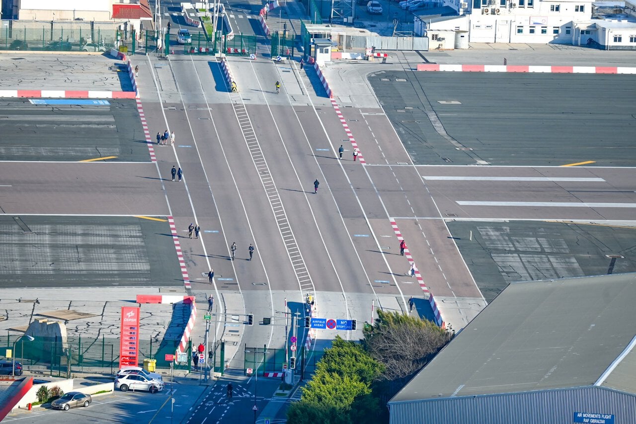 Pedestrians crossing Gibraltar airport runway border