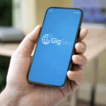 Smartphone displaying the GigSky eSIM app on screen while being held in a hand indoors