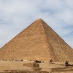 Great Pyramid of Giza with camels and desert landscape Egypt