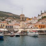 Hydra harbour clock tower and waterfront Saronic Islands Greece