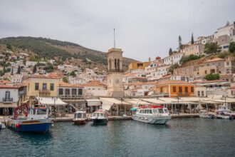 Hydra harbour clock tower and waterfront Saronic Islands Greece