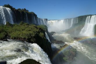 Iguazu Falls waterfalls on the Argentina Brazil border with rainbow and river