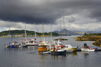 Kyle of Lochalsh harbour with boats and the Skye Bridge in the Scottish Highlands