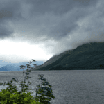 Loch Ness in the Scottish Highlands with low cloud over the hills and dark water