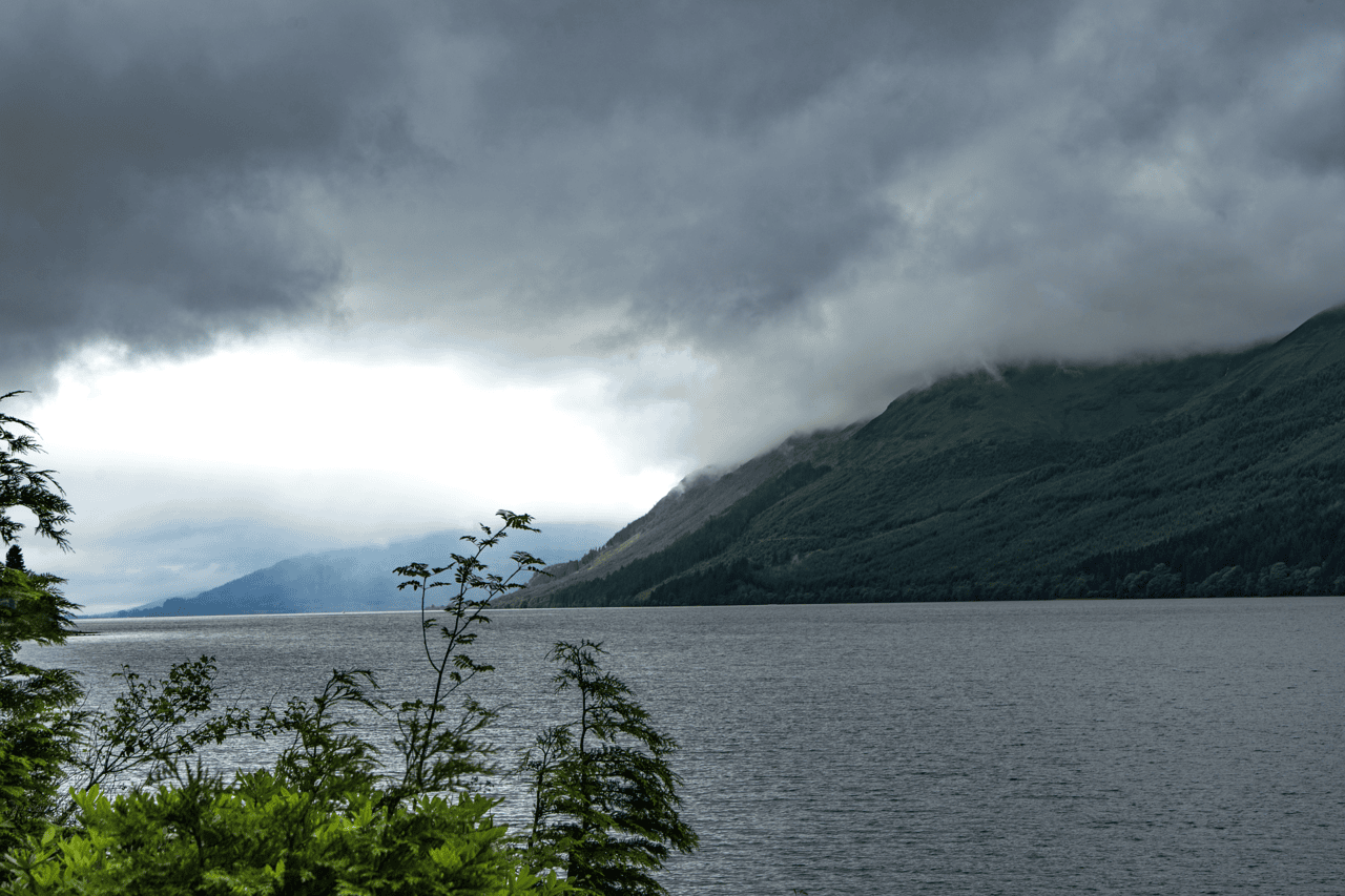 Loch Ness in the Scottish Highlands with low cloud over the hills and dark water