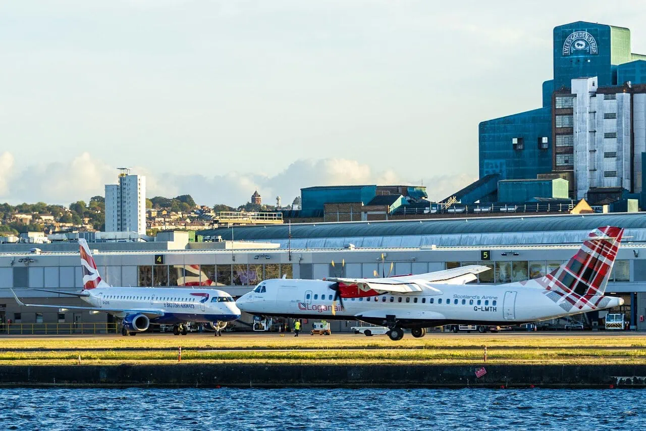 Loganair aircraft on runway at UK airport with terminal in background