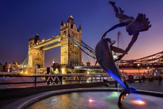 Tower Bridge London with Girl with Dolphin fountain in the foreground at sunset