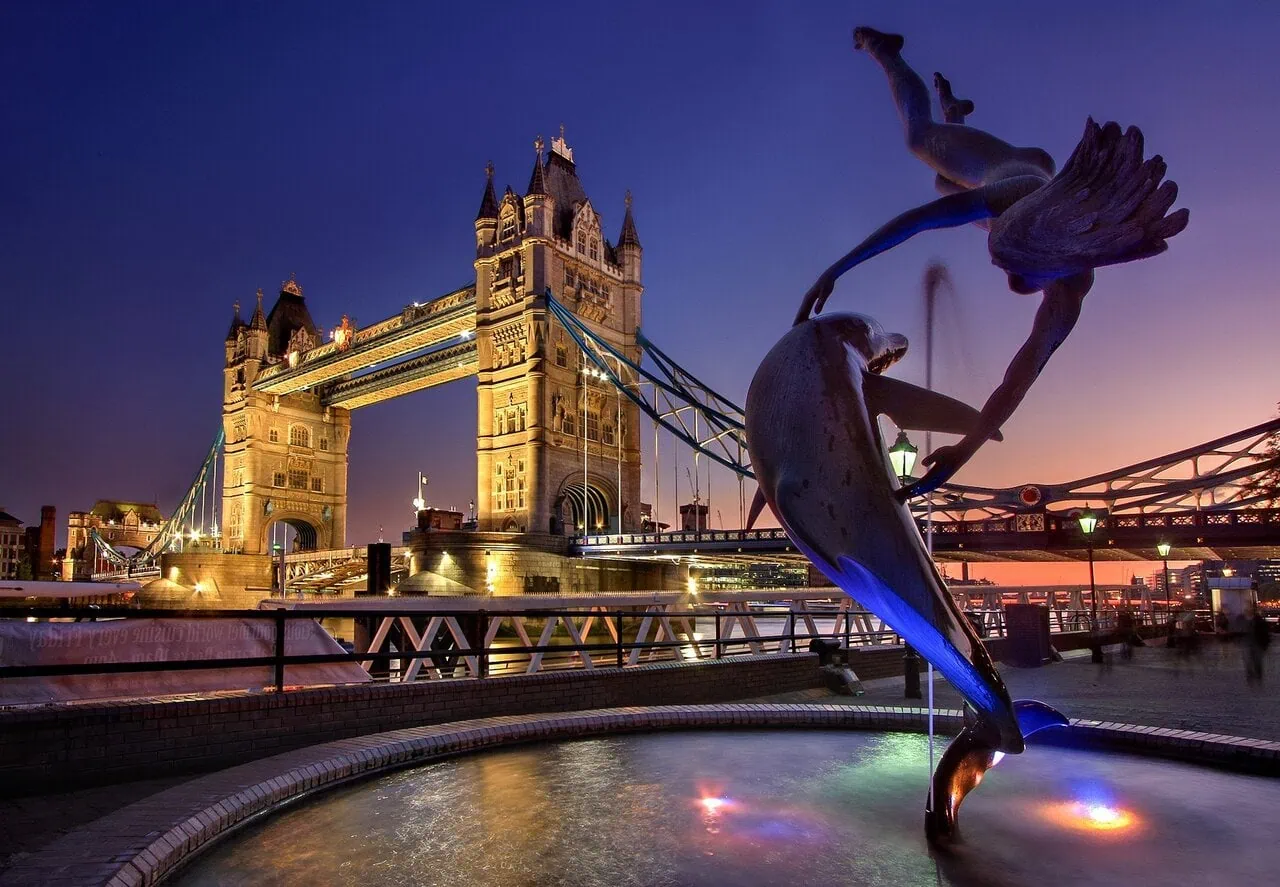 Tower Bridge London with Girl with Dolphin fountain in the foreground at sunset