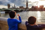 Children looking at Big Ben and the River Thames from the South Bank in London