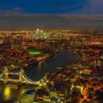 London skyline at night with Tower Bridge and River Thames illuminated